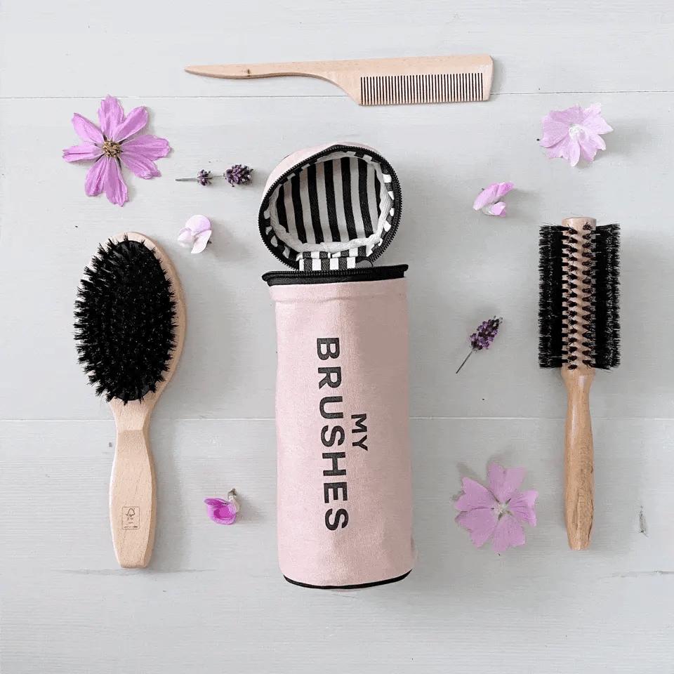 Pink Bag-all Hair Lover Gift Set with three hair tools and travel organizer pouch on light background with flowers