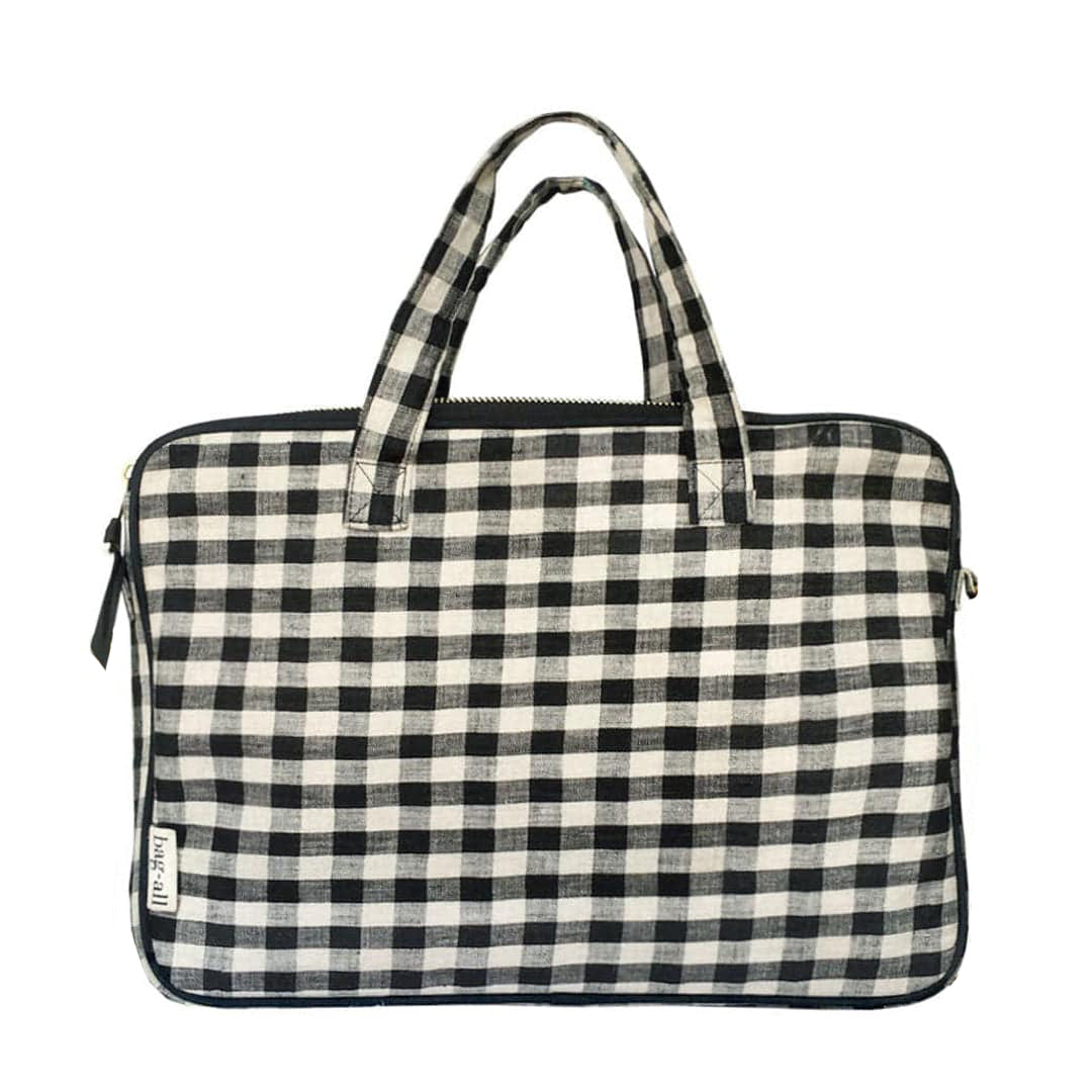 Bag-all Laptop Case 13" in black and white gingham pattern with dual handles, padded protection and front charger pocket. Stylish linen sleeve with crossbody option.