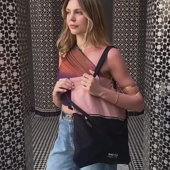 Woman wearing Bag-all 3-Way Tote in Pink/Black as a crossbody. Versatile, stylish, and perfect for travel