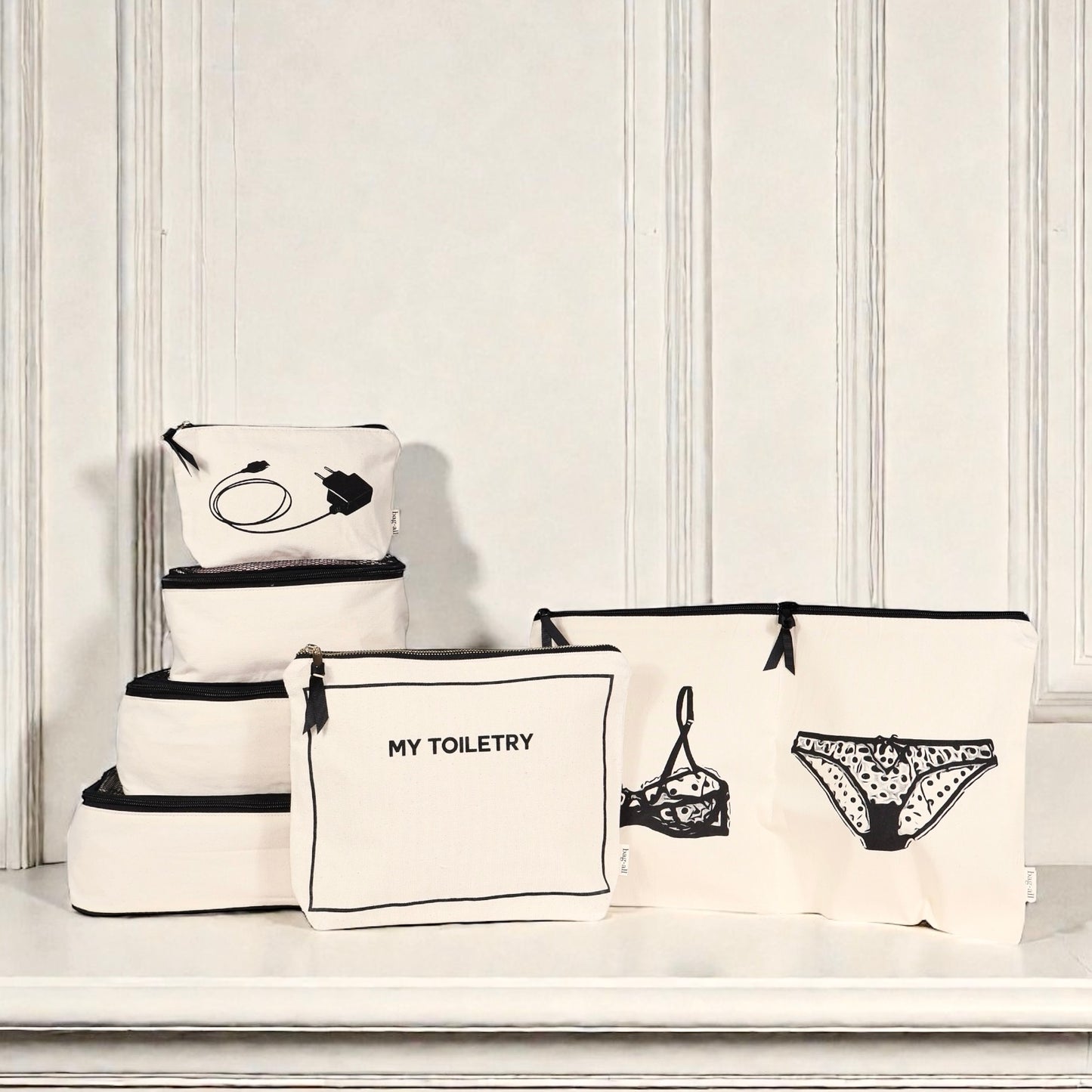 Cream Bag-all Weekend Essential Packing Set 4-Pack with toiletry, lingerie, and organizer pouches on white surface