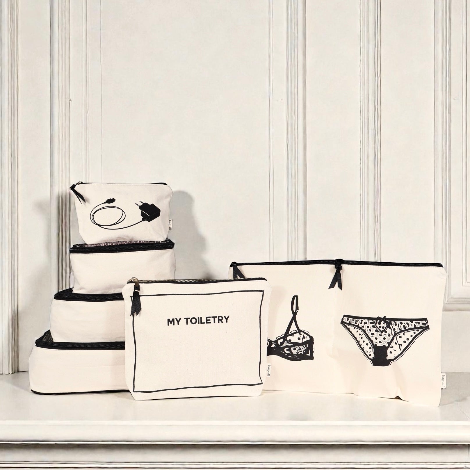 Cream Bag-all Weekend Essential Packing Set 4-Pack with toiletry, lingerie, and organizer pouches on white surface