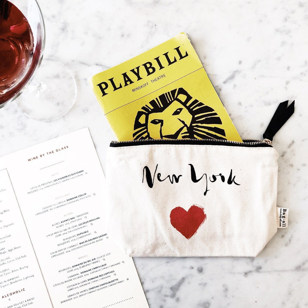
                                      
                                        New York heart case holding a playbill. 
                                      
                                    
