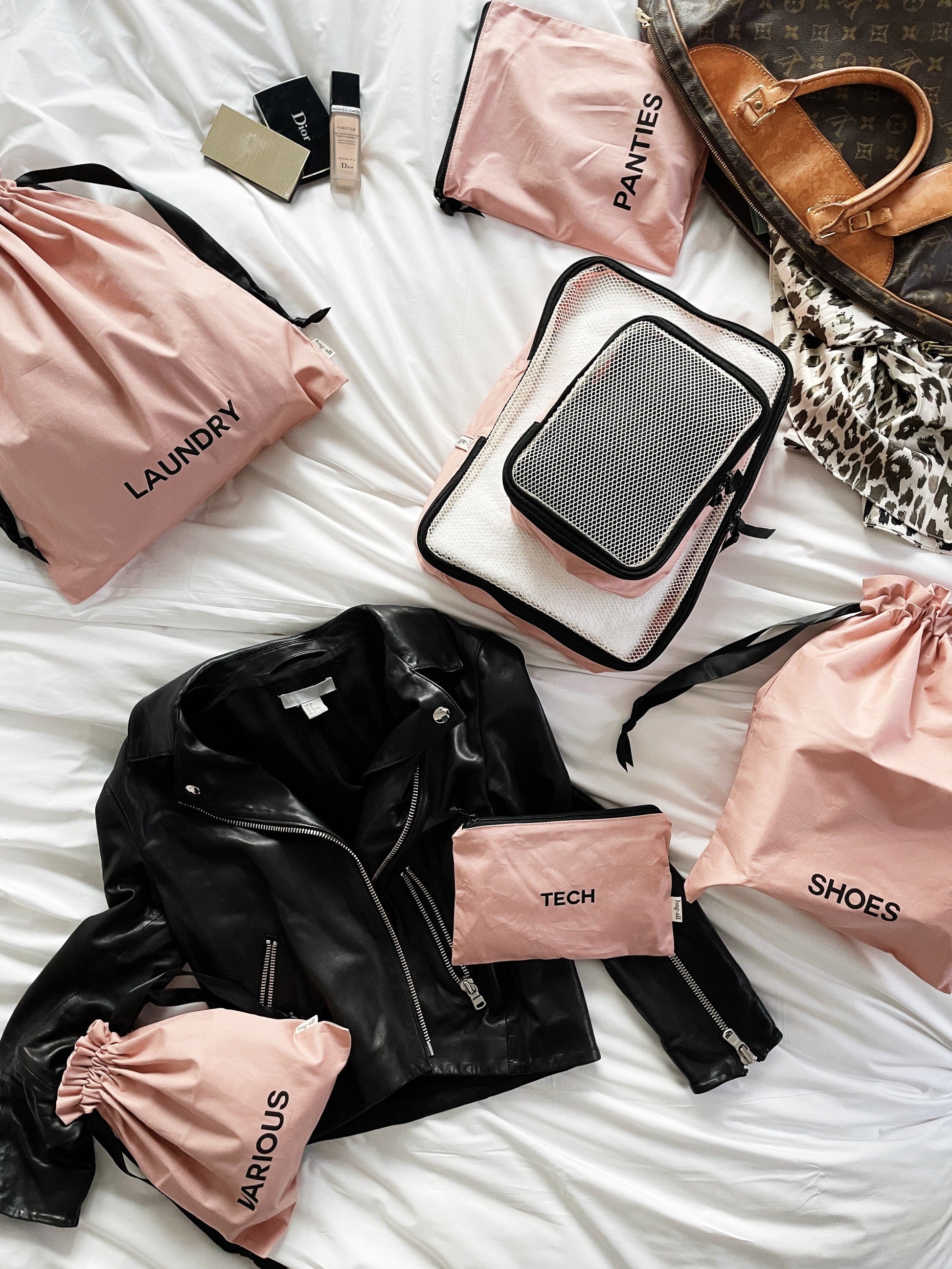 Bag-all BA Travel Set, 8-Pack in Pink/Blush. Stylish packing organizers including laundry, shoes, socks, tech, and various pouches for travel