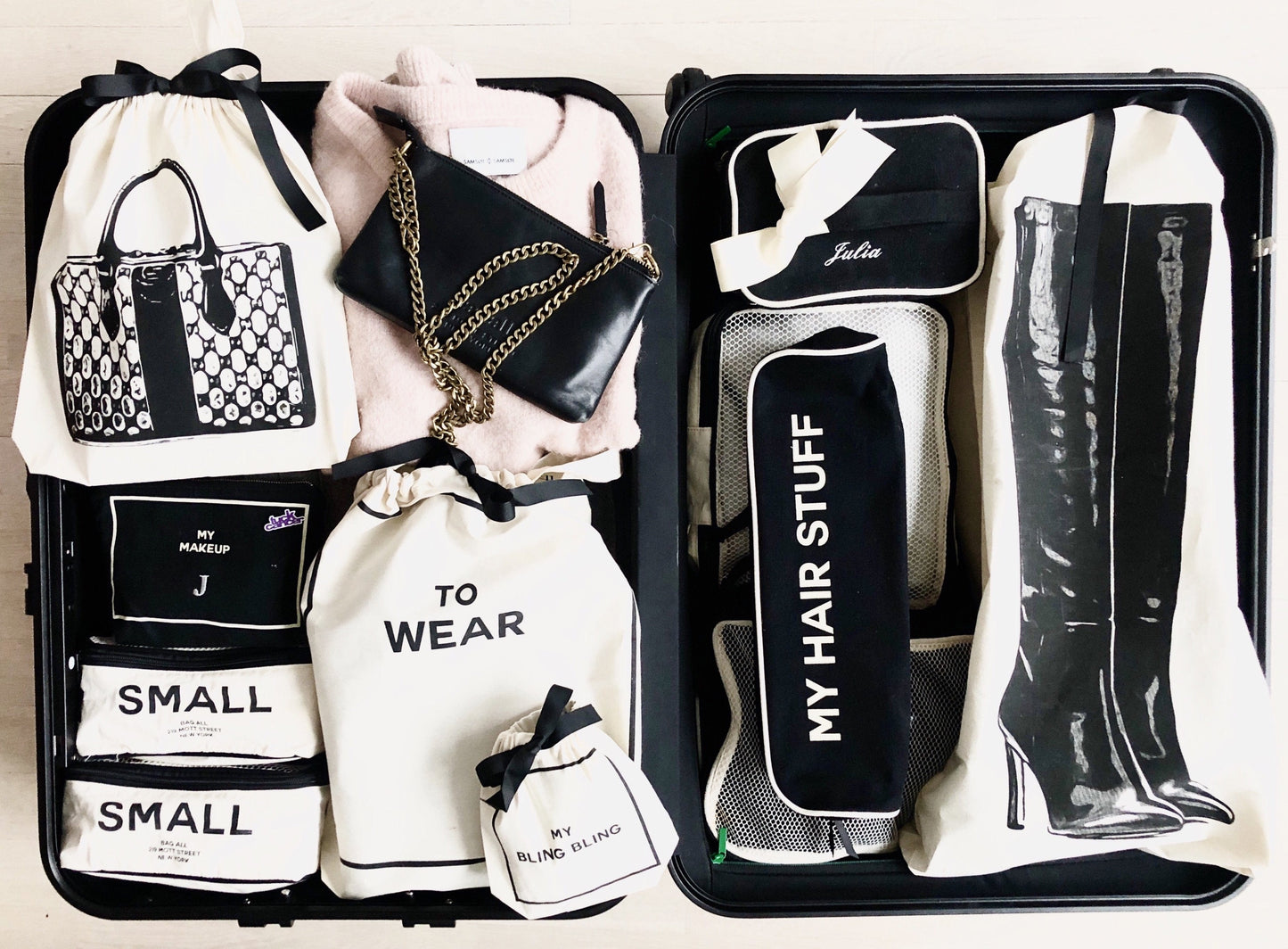 
                                      
                                        Suitcase packed with mini leather bag, tall classic boot bag, hair stuff case, three packing cubes for traveling and more. 
                                      
                                    