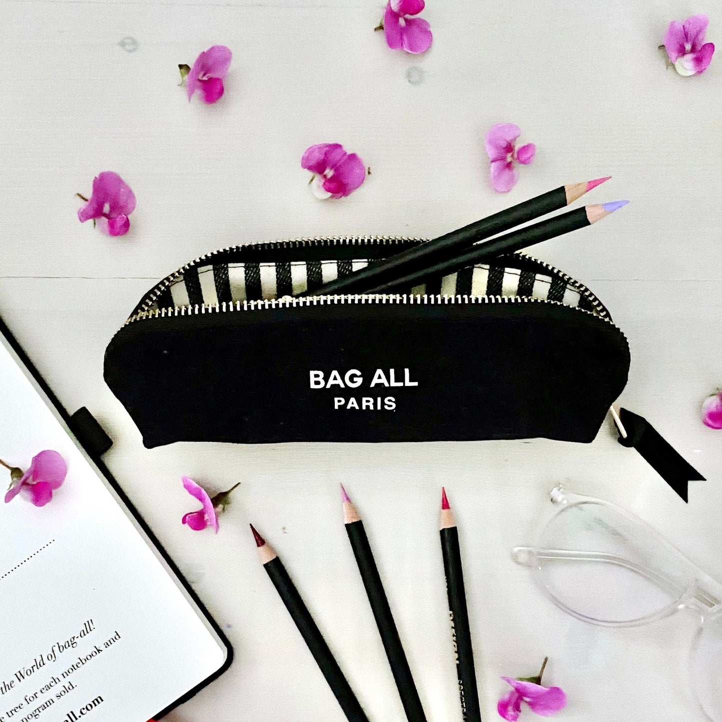 black bag-all pencil case with a striped interior. 
