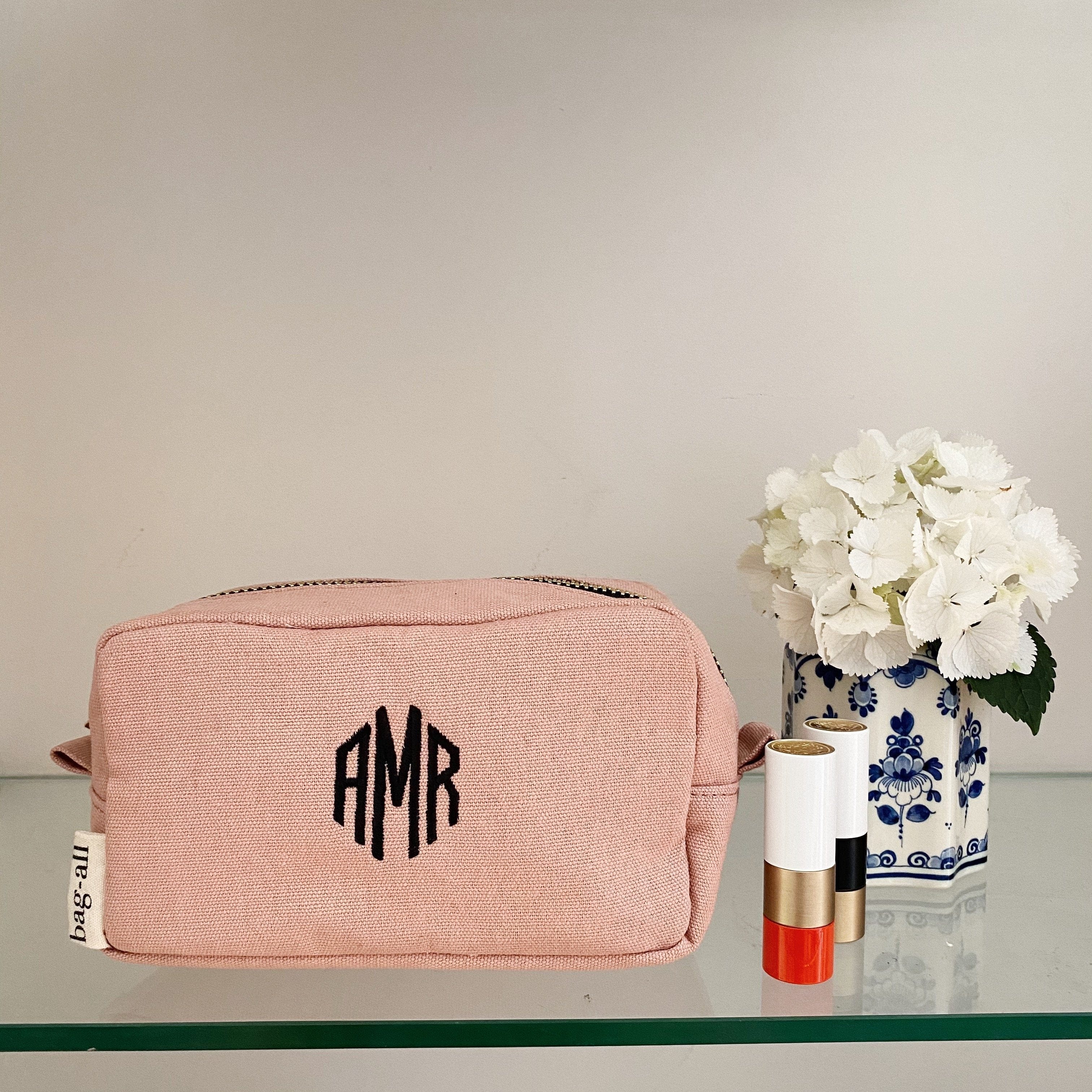 Pink Souki toiletry case with initials monogrammed on the front. 