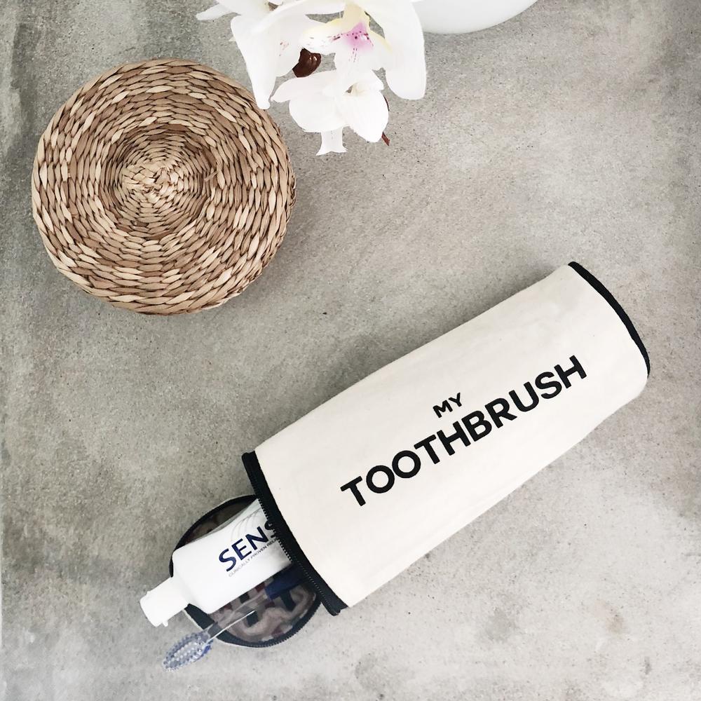 Travel tooth brush case with a toothbrush and toothpaste. 