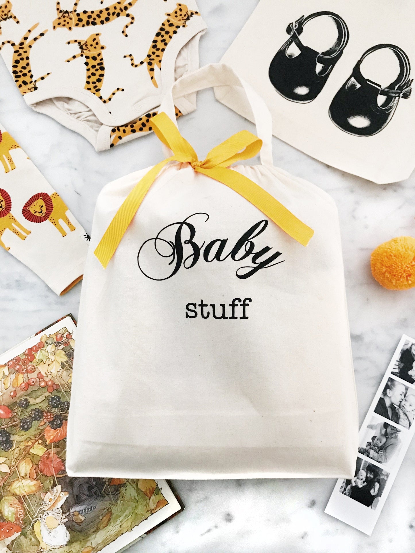 
                                      
                                        Baby stuff bag with a yellow ribbon. 
                                      
                                    