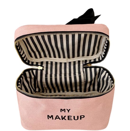 Inside of the pink cosmetic case showing the black and white striped interior. 