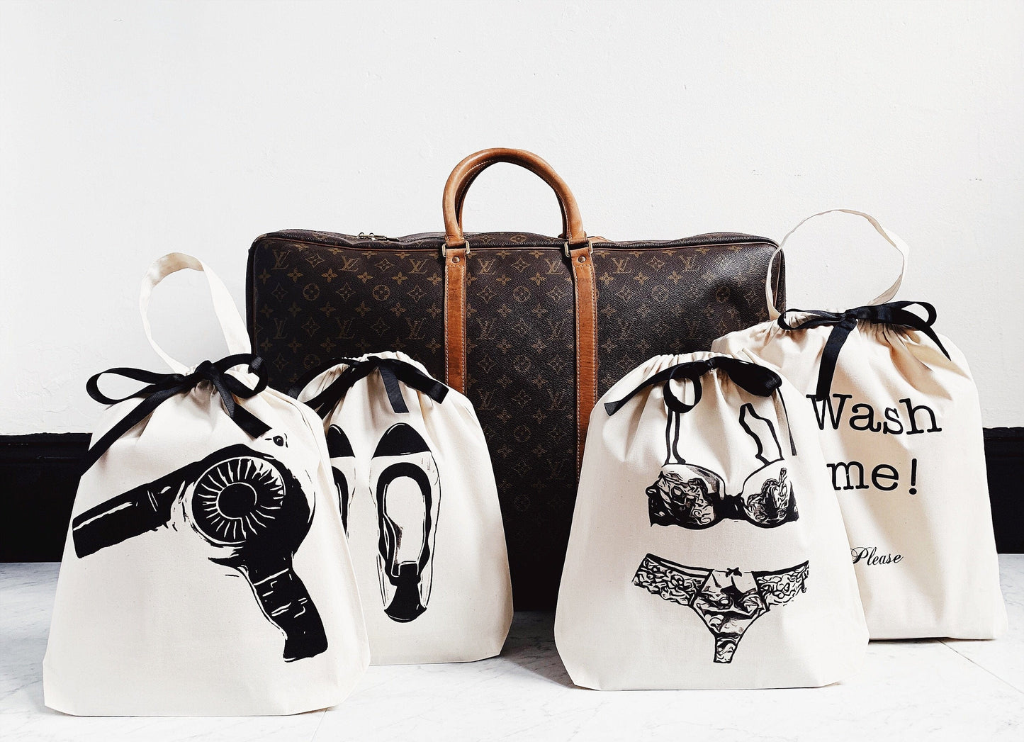 
                                      
                                        Hairdryer bag, lingerie bag, ballet flats bag, and a laundry bag in a louis vuitton duffle bag. 
                                      
                                    